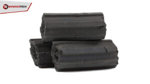 Close-up of glowing hexagonal sawdust charcoal briquettes stacked for high-heat, consistent grilling on a professional BBQ. The image highlights the clean, smokeless burn of the eco-friendly fuel.