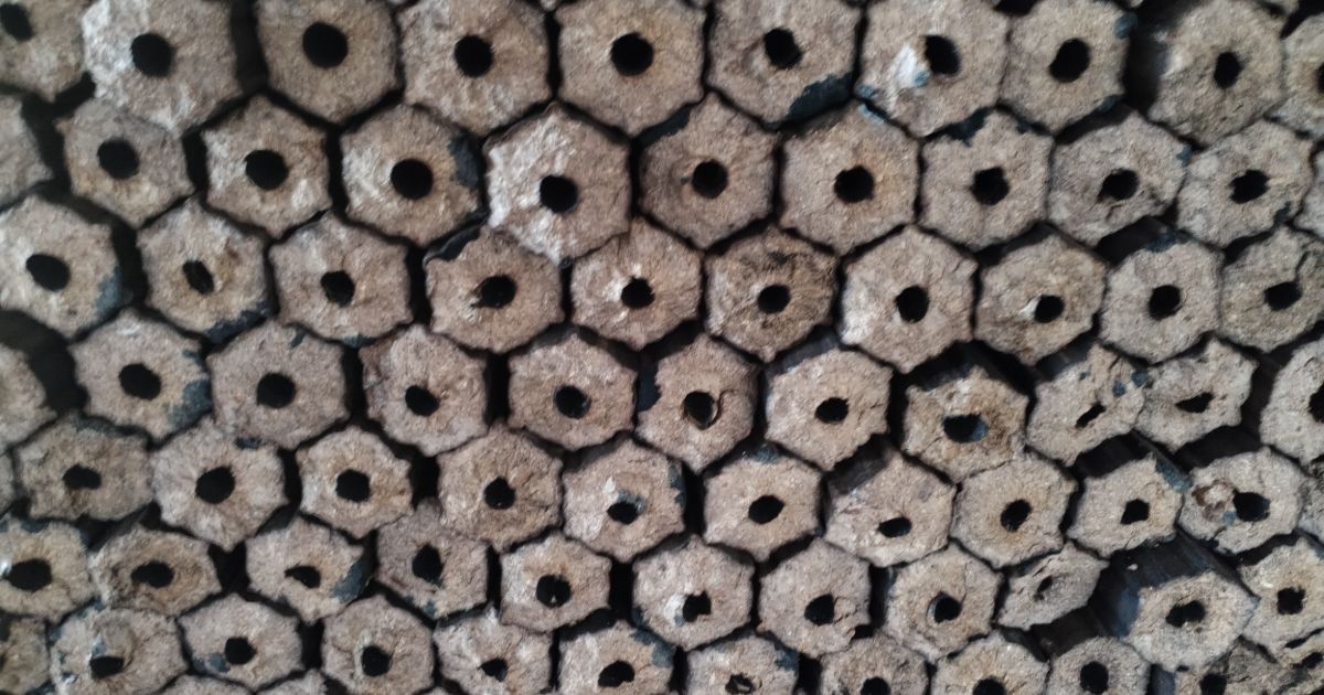 Close-up of stacked hexagonal sawdust wood briquettes for industry
